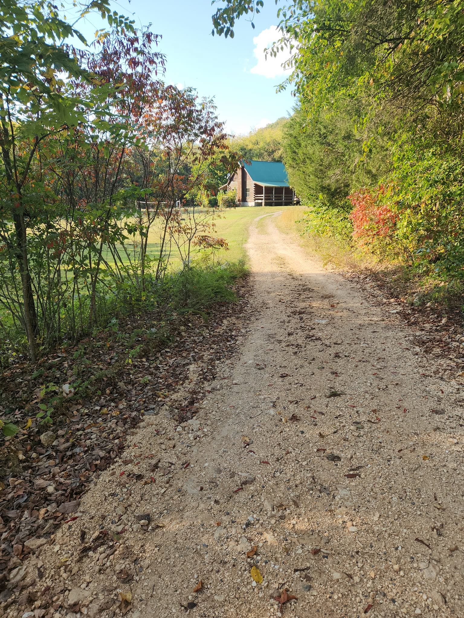 Gravel trail leading toward Kindling Trail Cabin in fall