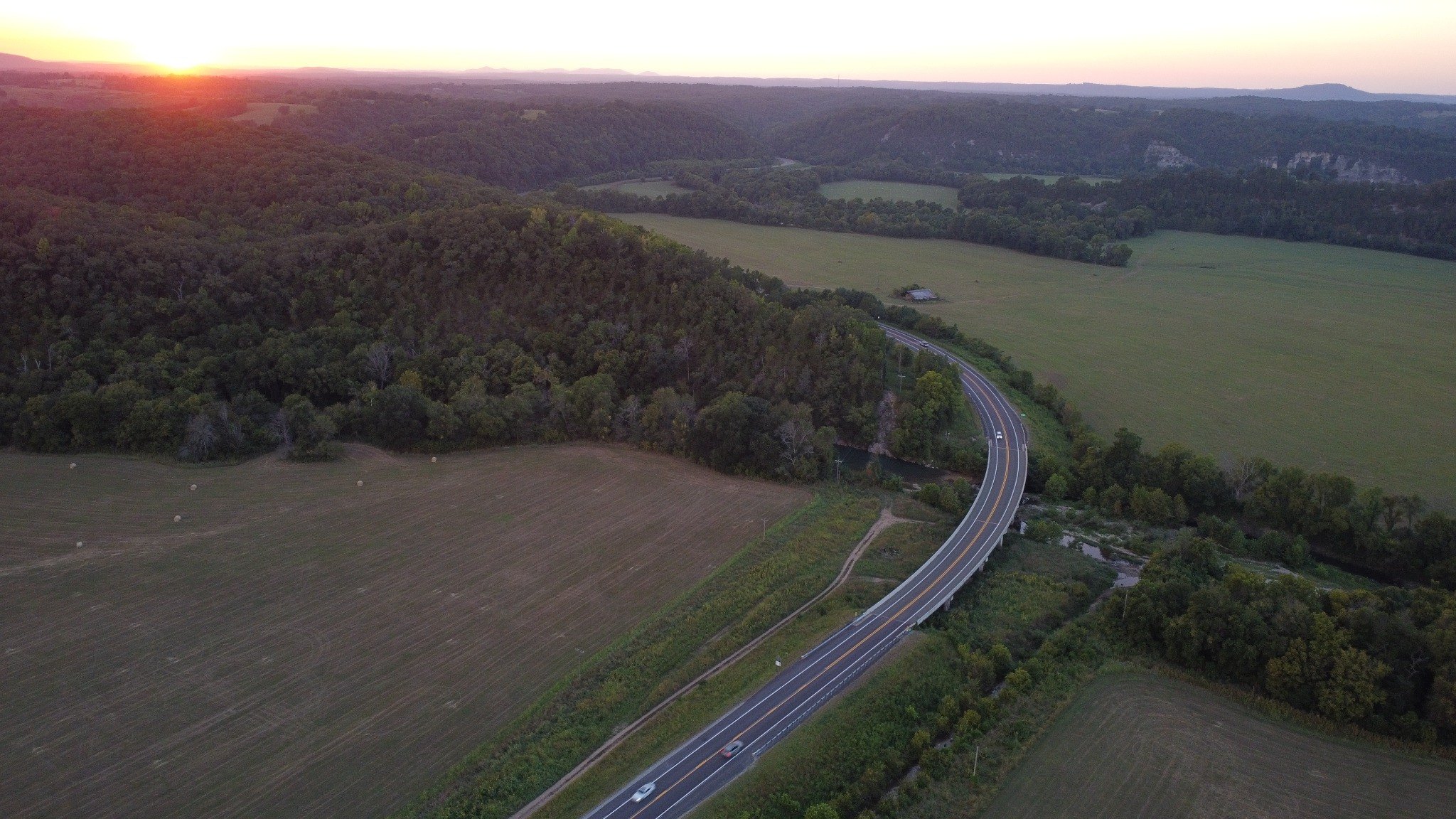 Aerial sunset view over the highway and surrounding Ozark countryside